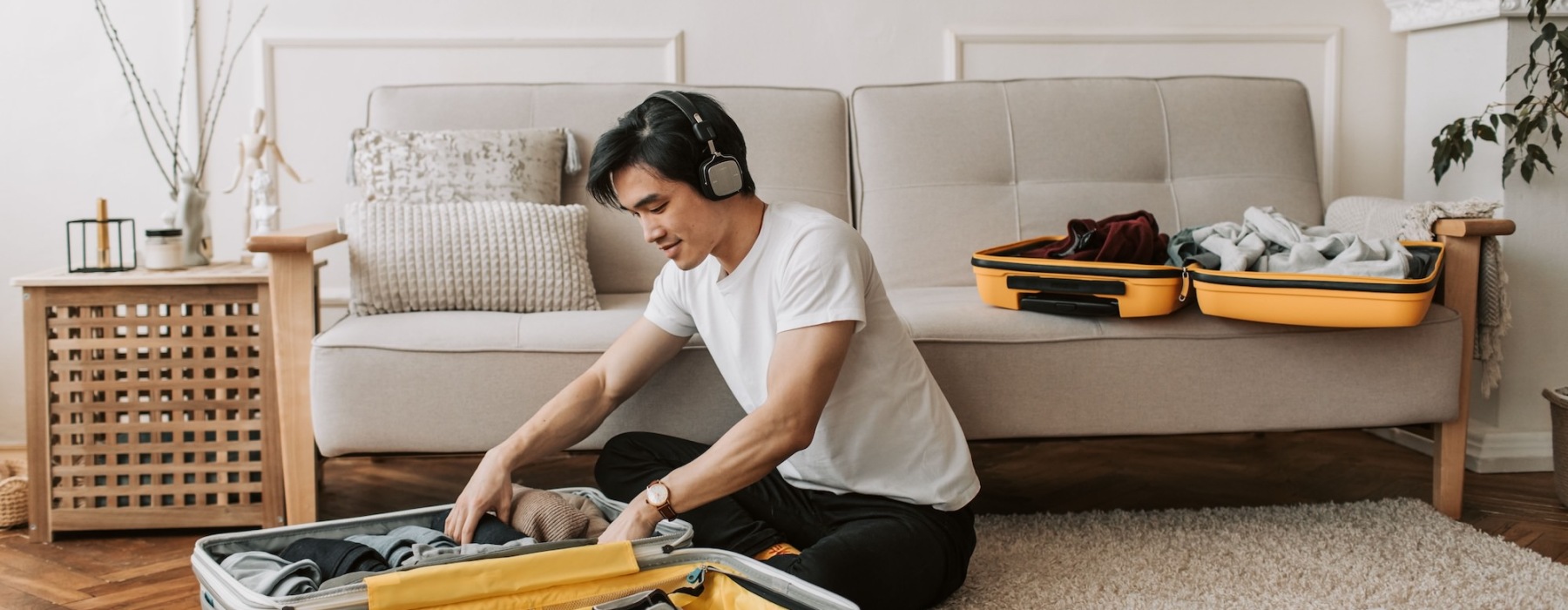 a person packing a suitcase in a living room