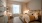 Bedroom featuring a bed, nightstands, dresser and light/ brown decor