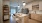 Kitchen featuring an Island and neutral tones looking into the living room