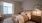 Bedroom featuring a bed, nightstands, a dresser, mirrors and neutral toned decor